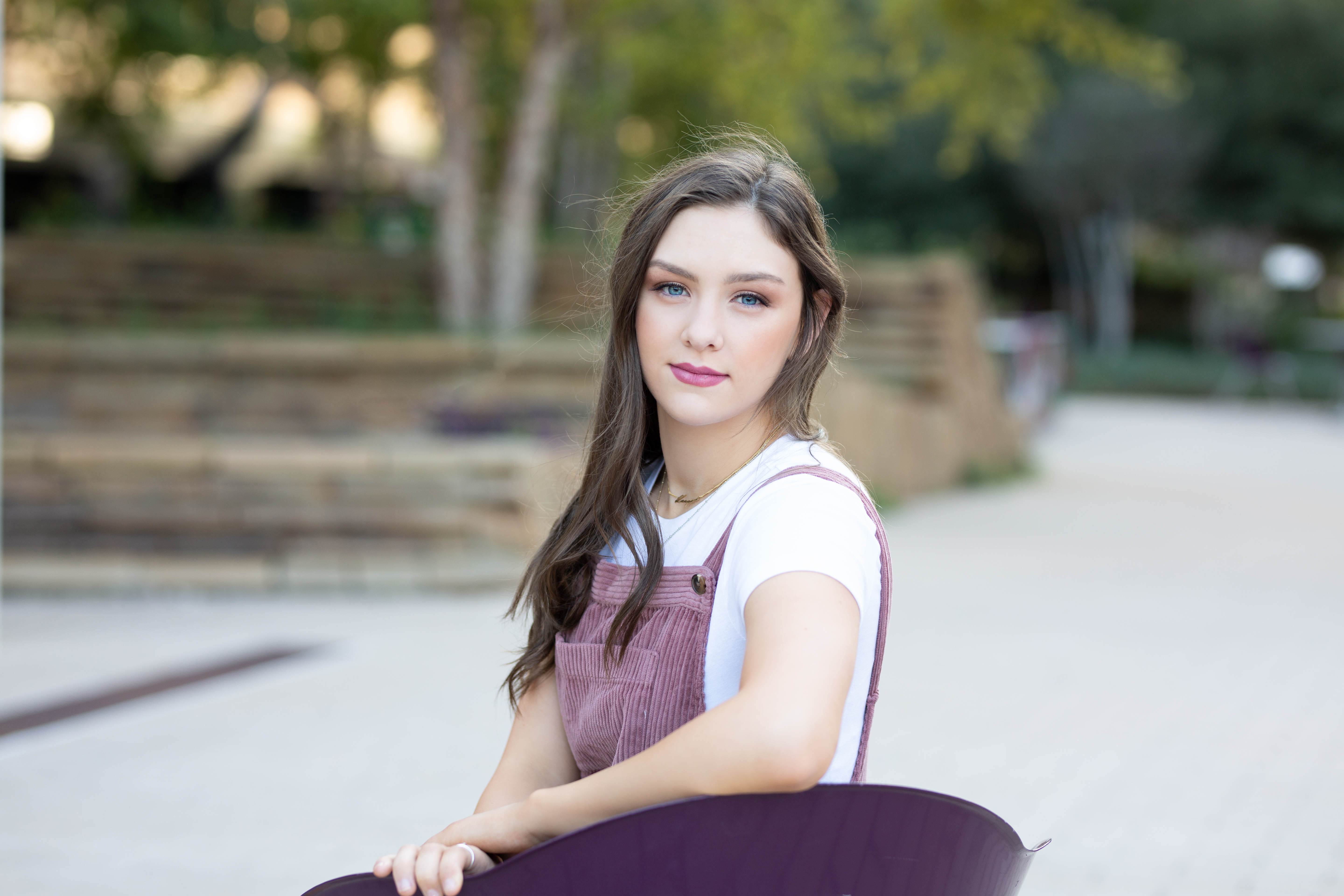 senior girl posing in a chair in downtown OKC for her senior photos
