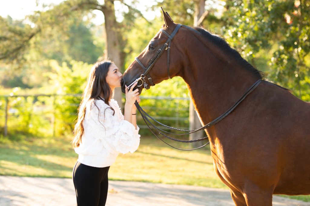 senior girl kissing her horse