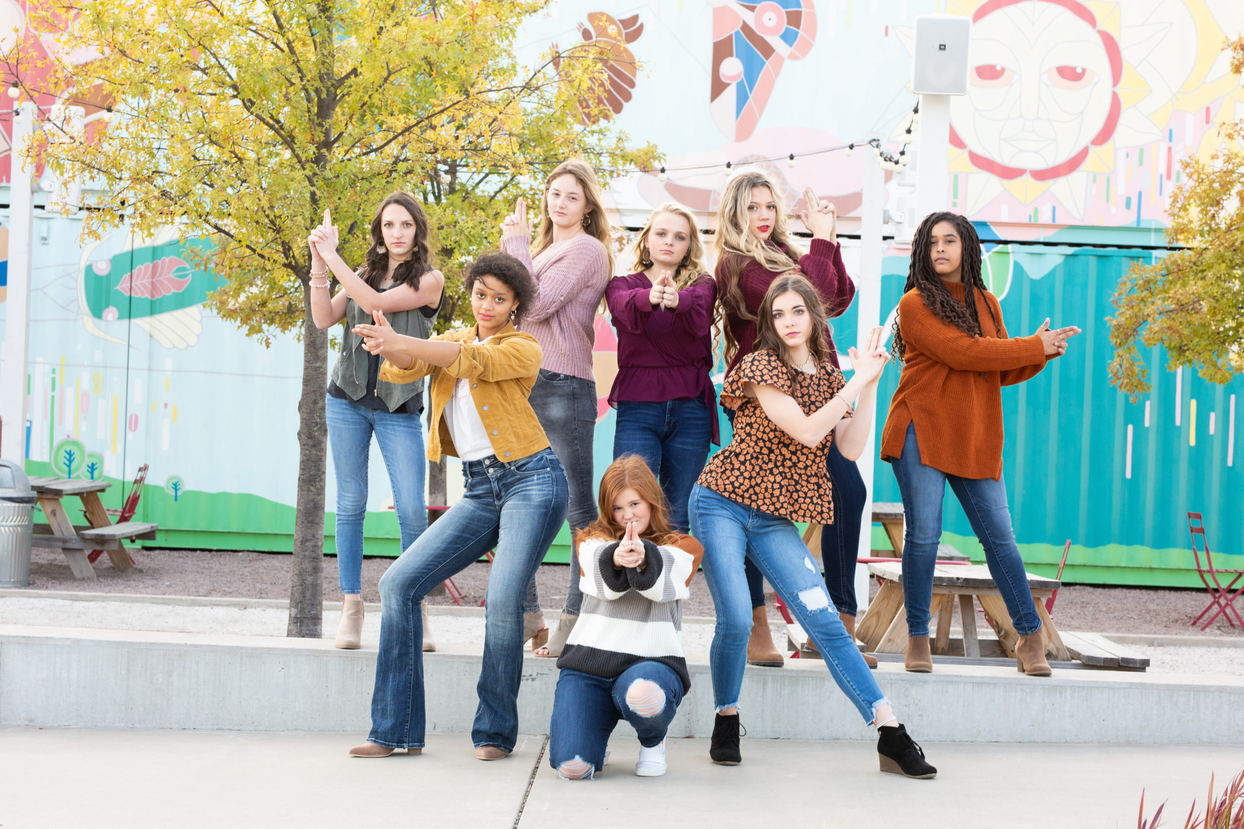 teen girls posing like Charlie's Angels for a picture