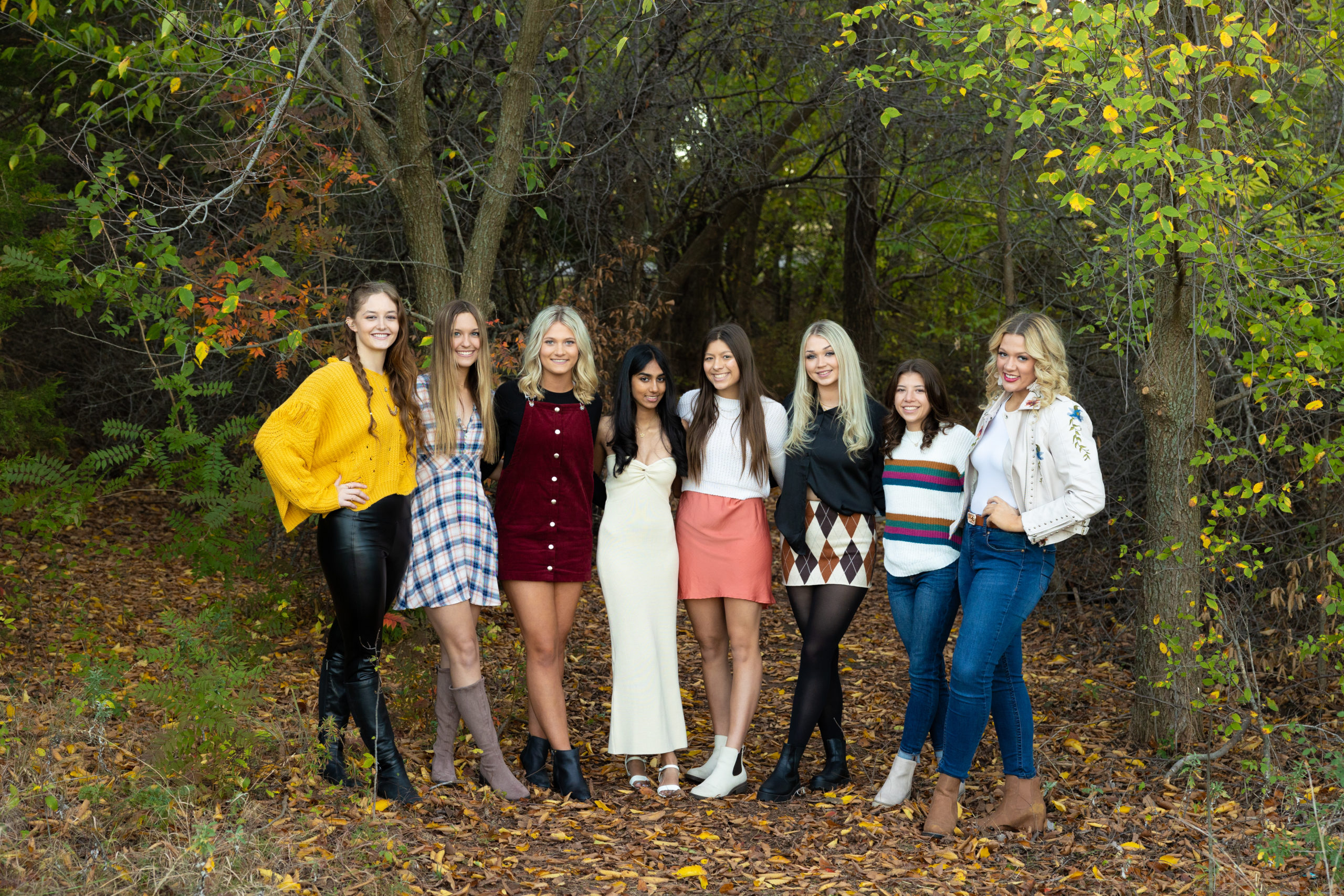 group of senior girls posing for senior model team pictures in the oklahoma fall colors